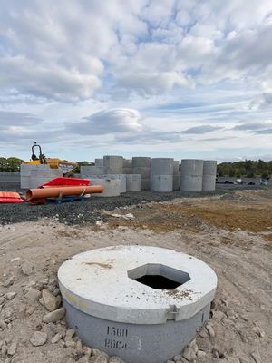 Concrete drainage rings and a partially buried manhole chamber with hexagonal opening at the Copart Dunfermline construction site